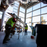 Construction workers work on the interior of a building