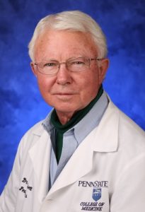 A head-and-shoulders professional photo of Dr. John Dossett in a lab coat and glasses.