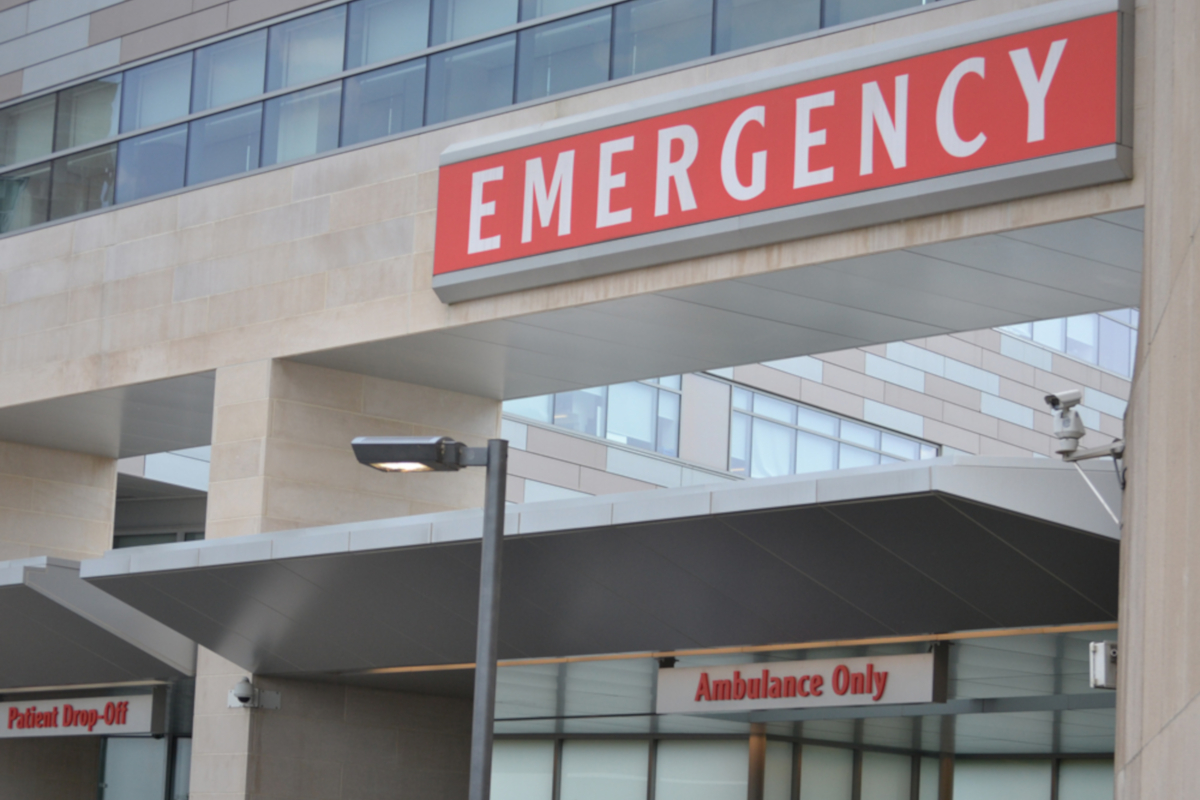 A close-up image of a large sign reading “EMERGENCY” at the Hershey Medical Center Emergency Department entrance.