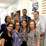 Eight physician assistant students from the Class of 2022 strike a pose at LionCare, Penn State College of Medicine’s free student-run clinic at Bethesda Mission, a shelter for homeless people in Harrisburg. Each student is smiling and has a stethoscope wrapped around their neck.