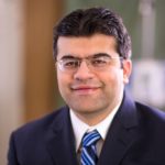 Dr. Faisal Aziz, vascular surgeon with Penn State Heart and Vascular Institute, wearing a suit and tie.