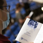 A man in glasses looks at a piece of paper. On the paper are the words “Oath ceremony” and a rendering of the Penn State Nittany Lion.
