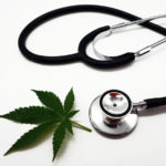 A stethoscope with a medical marijuana leaf on a white background.