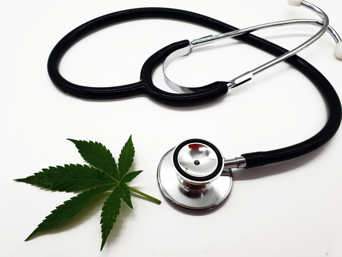 A stethoscope with a medical marijuana leaf on a white background.