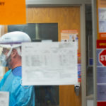 A person in full personal protective equipment in a hospital