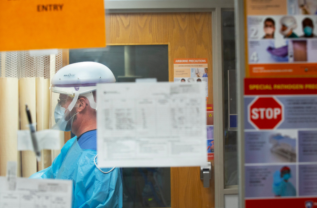 A person in full personal protective equipment in a hospital