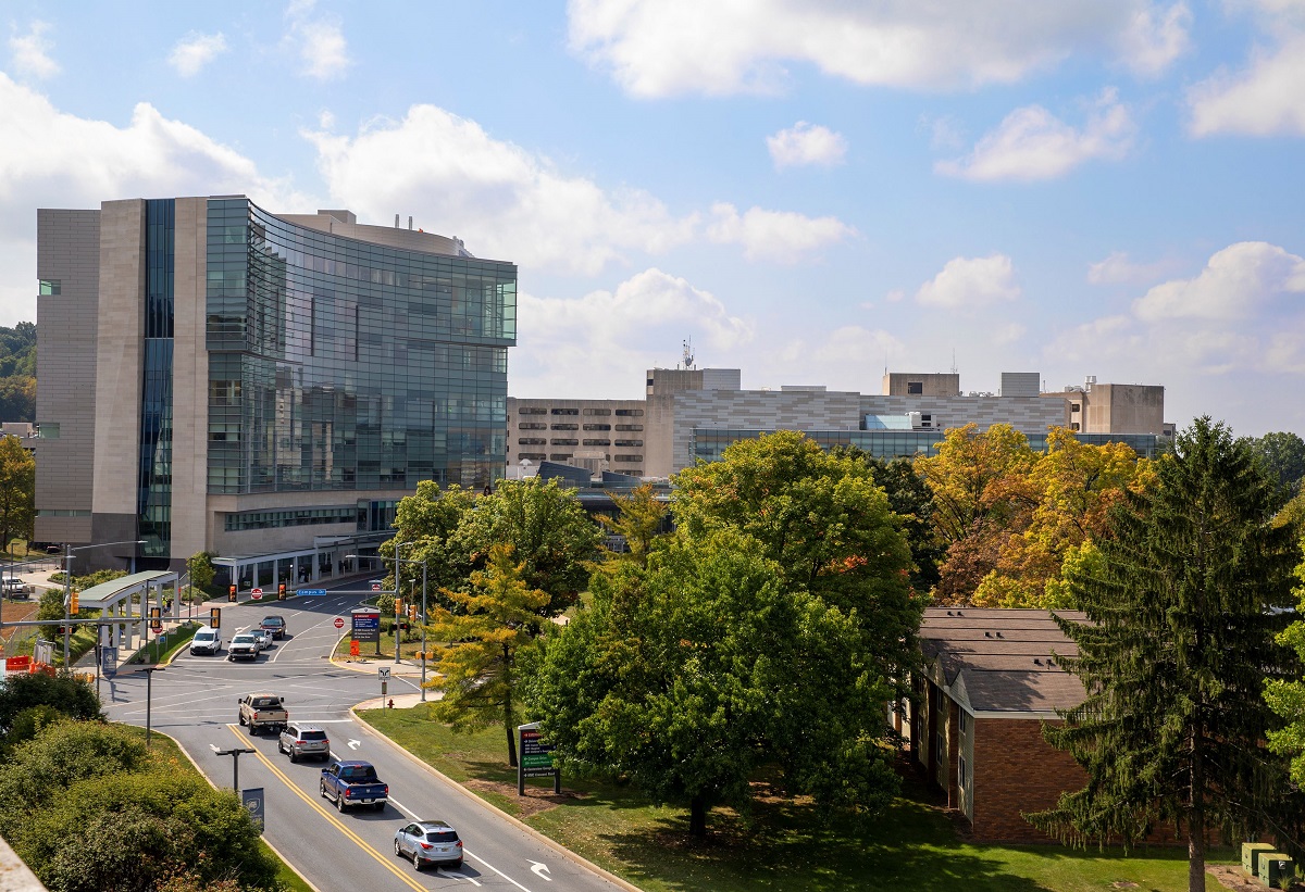 Image shows the outside of Hershey Medical Center with trees in fall colors.