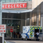 Photo shows an ambulance parked outside of an emergency department