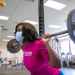 Natasha Renee Burse, a graduate student at Penn State College of Medicine, lifts weights at the University Fitness Center.
