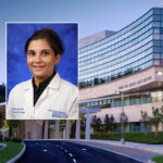 A head and shoulders professional portrait of Monika Joshi, against a background image of Penn State Cancer Institute