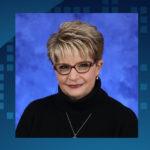 A portrait of Kathy Remlinger next to the Nittany Lion Statue.