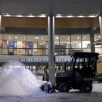 A man drives a tractor with a snowplow during a snowstorm in front of the Hershey Medical Center main entrance on Dec. 17, 2020.