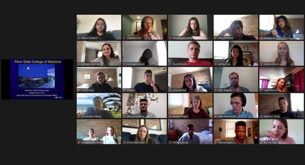The faces of students participating in a virtual meeting appear on a screen in a grid of five columns and five rows, with a small image of the presenter’s screen to the left of the students’ faces.