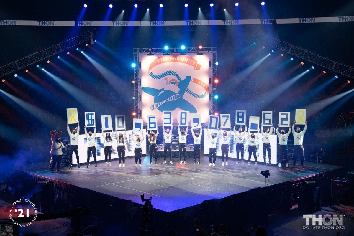 Students hold up placards that spell out the total amount raised during THON.