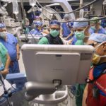 A team of cardiology, cardiothoracic surgery and anesthesia clinicians wear scrubs, masks and caps during a procedure in the Operating Room at Penn State Health Milton S. Hershey Medical Center in December 2020.