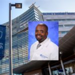 Photo of African American male doctor wearing physician white coat with PennState Health brand.