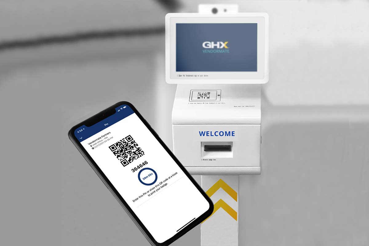 A smartphone with a QR code on it is shown in front of a kiosk that has the GHX Vendormate logo on it. The bottom of the kiosk says “welcome.”