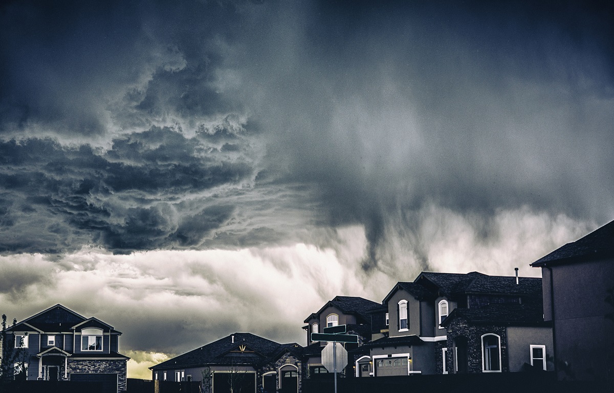 Dramatic storm clouds over a residential neighborhood.