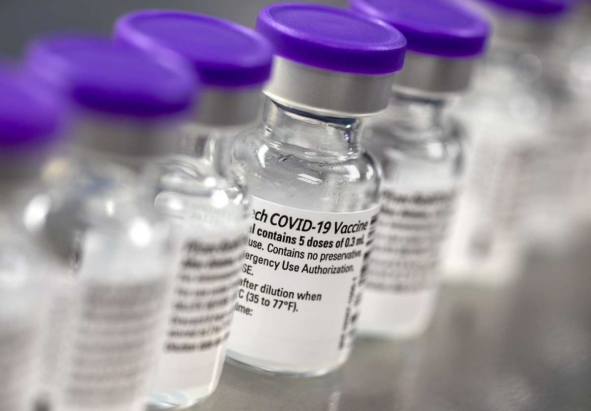 Vials of COVID-19 vaccine are lined up in a laboratory.