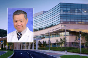 A head and shoulders professional portrait of Dr. Patrick Ma against a background image of Penn State Cancer Institute