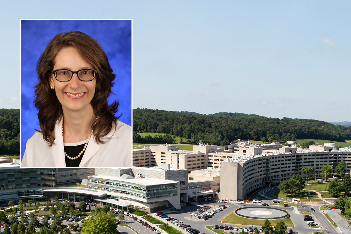 A head and shoulders professional portrait of Dr. Erika Saunders against a background image of Penn State College of Medicine and Penn State Health Milton S. Hershey Medical Center.