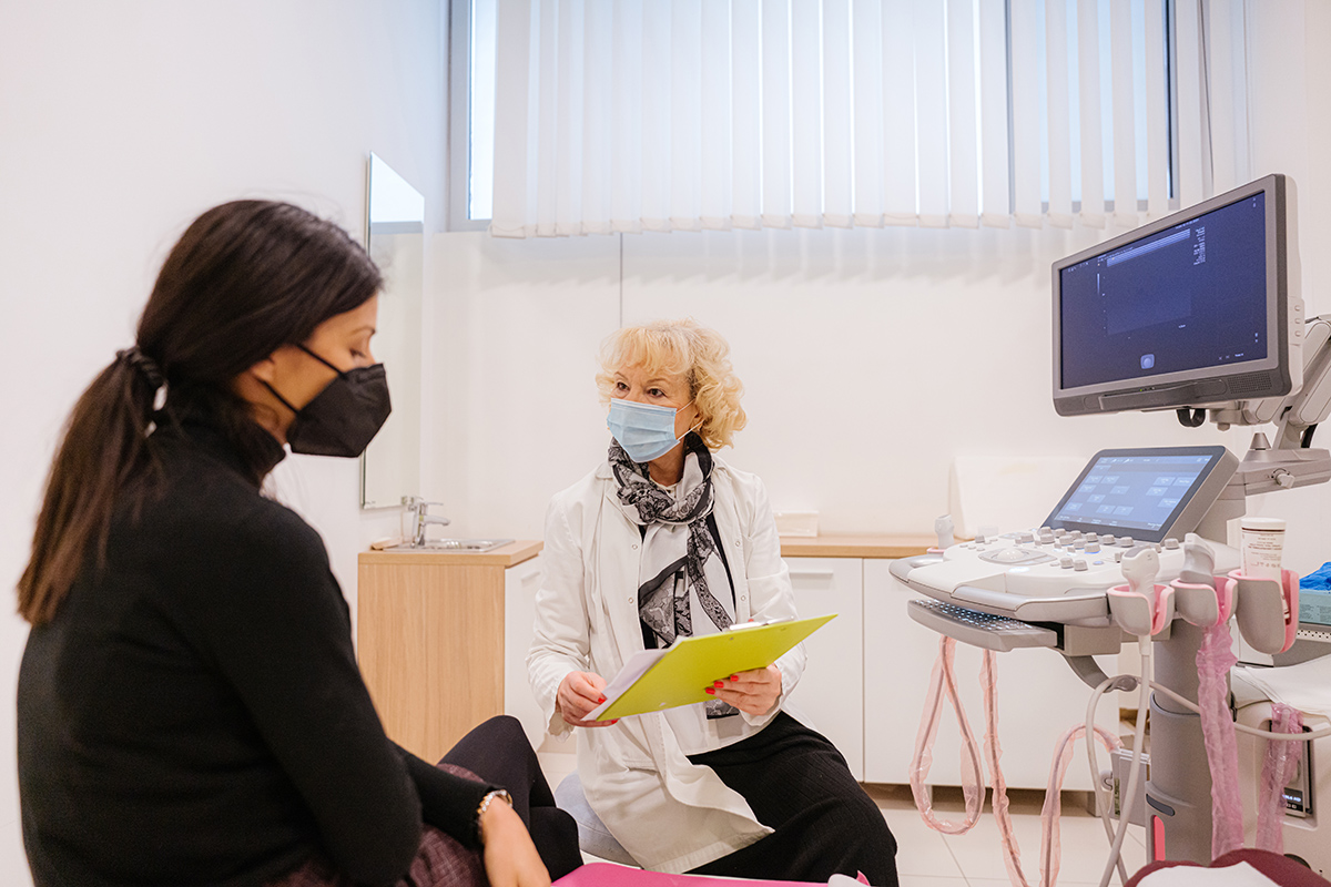 Doctor and patient with protective face masks during the medical examination