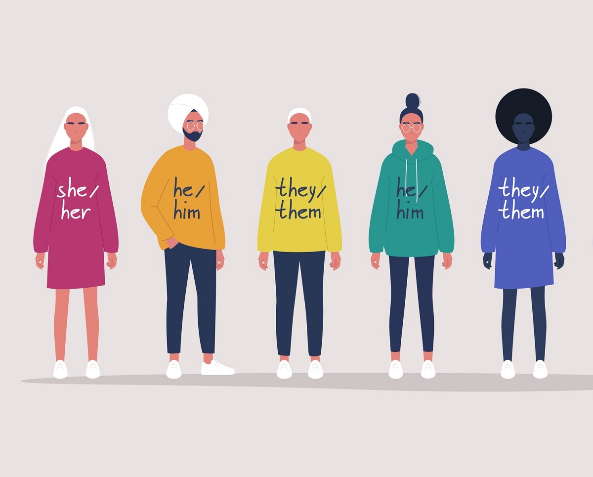 Illustration of a group of people lined up side by side with varying pronouns on the front of their shirts.
