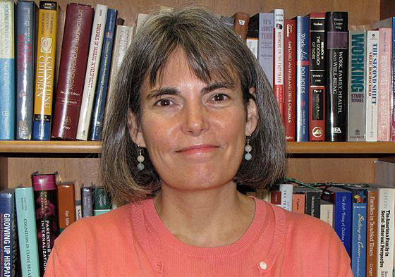 A head-and-shoulders portrait of Susan McHale, PhD, with a shelf of books behind her.
