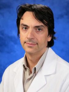 Dr. Philippe Haouzi is featured in a professional headshot wearing a white coat