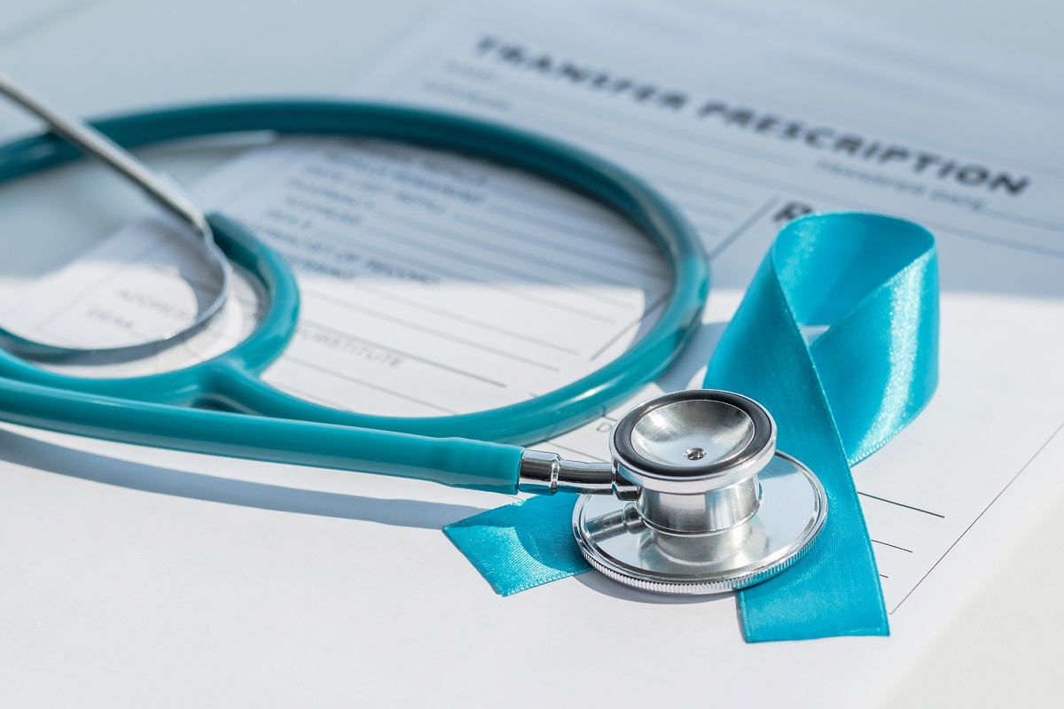 Blue ribbon symbolic of prostate cancer awareness campaign and men's health on patients health record prescription form with a stethoscope.