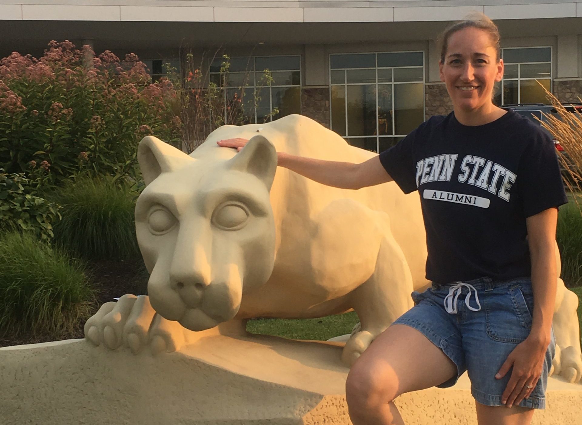 Susan Thurman, a critical care physician assistant, stands outside next to the Penn State Nittany lion statue.