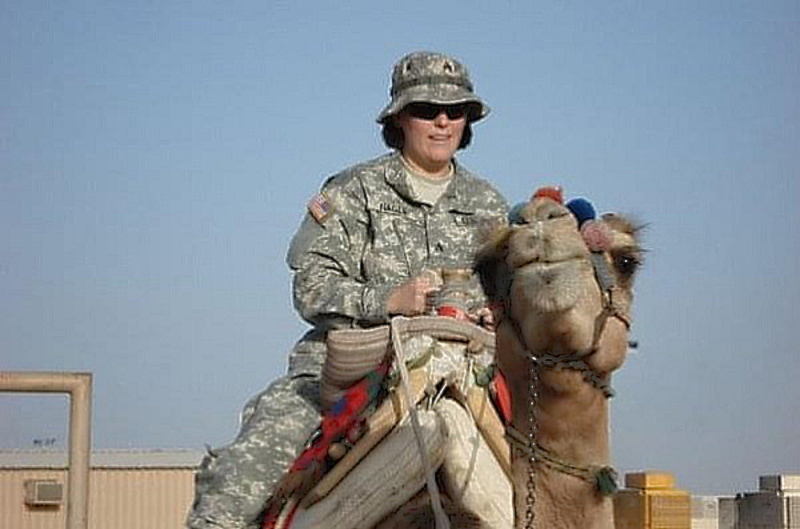 Elizabeth Nagle, a licensed practical nurse at Penn State Health Medical Group, Community Practice Division, rides a camel in Kuwait during Operation Iraqi Freedom, where she provided medical support to the Oklahoma National Guard during deployment to Iraq.