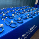 Stethoscopes on a table with a tablecloth that says Penn State College of Medicine