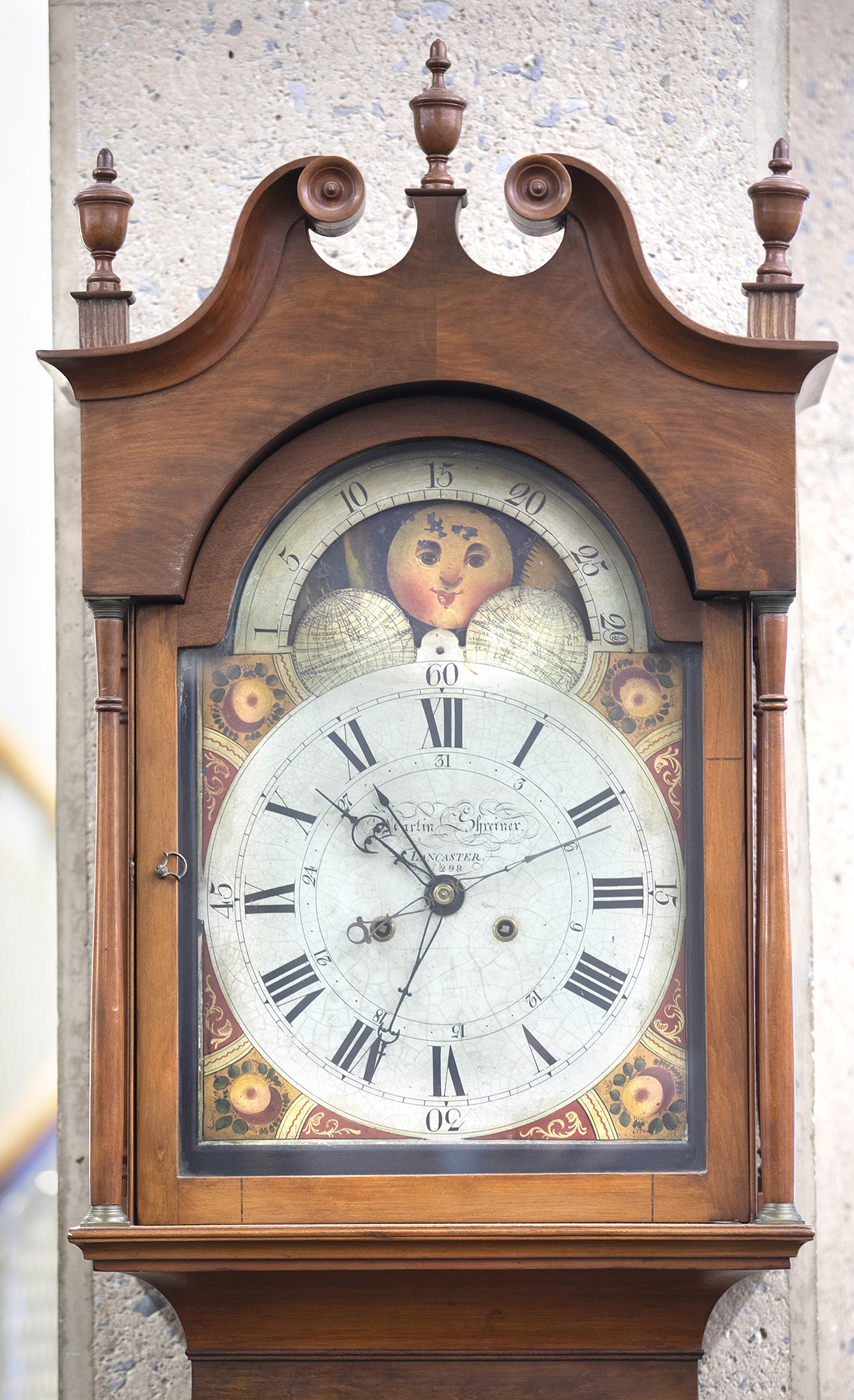 The front of an old grandfather clock