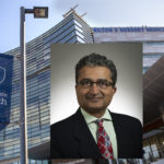 A headshot photo of Dr. Thiru Annaswamy is placed over a stock photo of Hershey Medical Center.