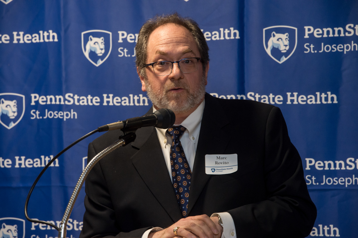 A man speaks at a podium