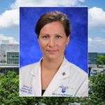 A head-and-shoulders professional portrait of Jill Eckert, DO, with Milton S. Hershey Medical Center in the background