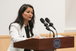 A woman speaks at a podium
