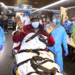 patient waves at hospital staff as he is discharged