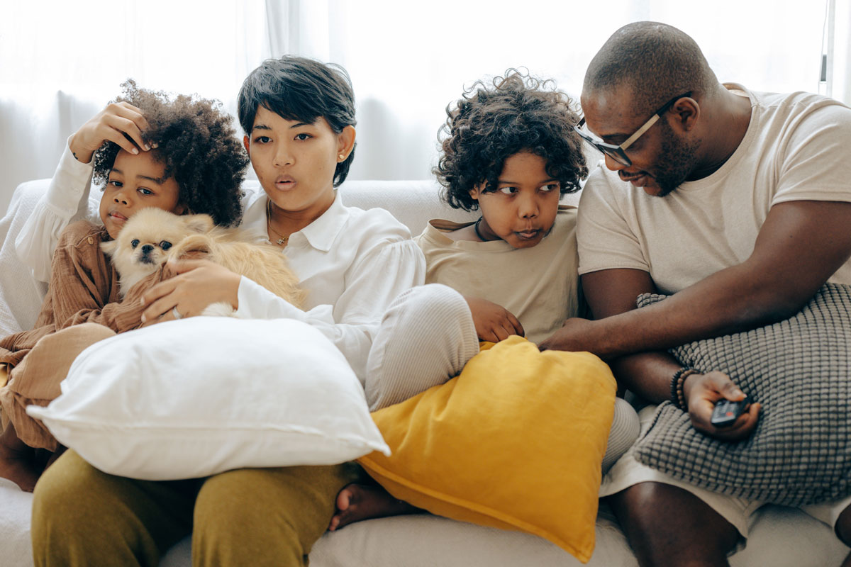 Family Sitting Together with their Dog