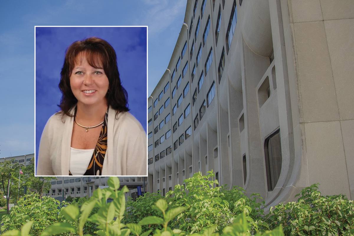 A head and shoulders professional portrait of Kelly Karpa against a background image of Penn State College of Medicine.