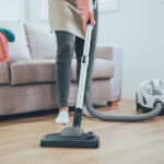 Photo of a person vacuuming their living room floor.