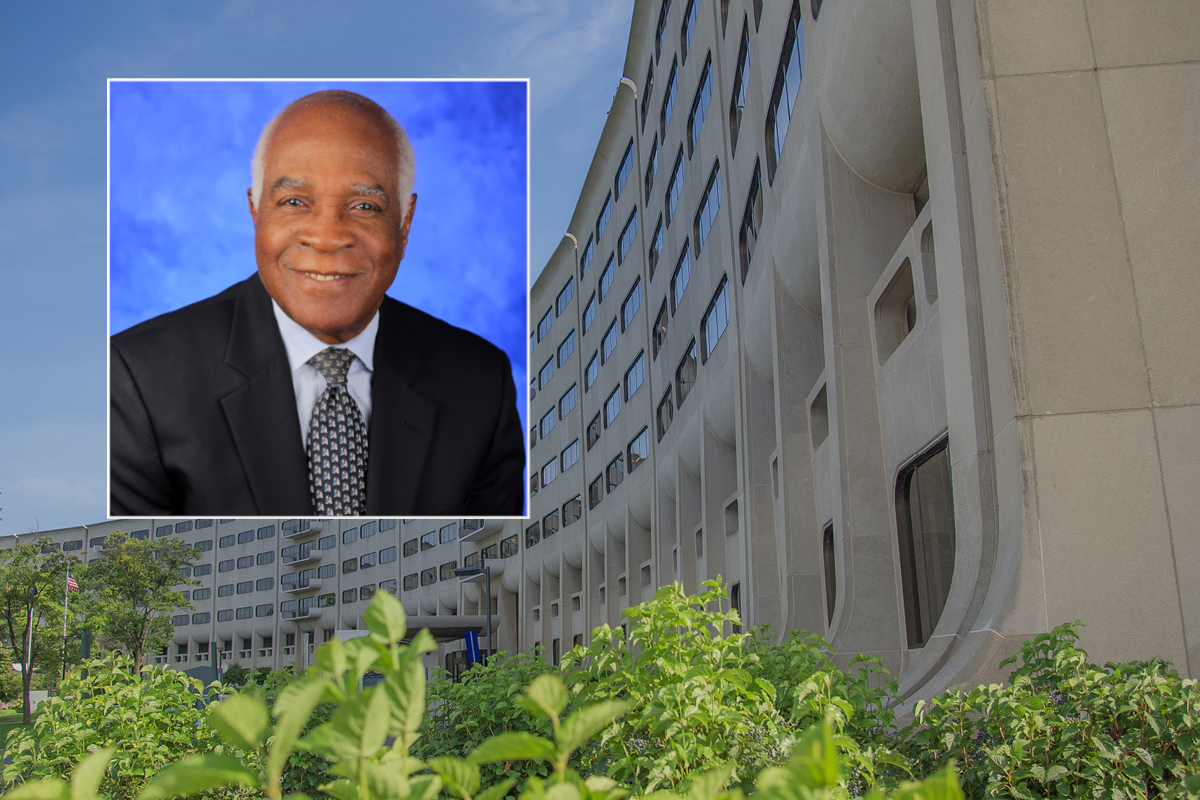 Dr. Rodrigue Mortel smiles in a professional portrait. He is wearing a suit, tie and shirt.