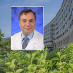A head and shoulders professional portrait of Dr. Dino Ravnic against a background image of Penn State College of Medicine.