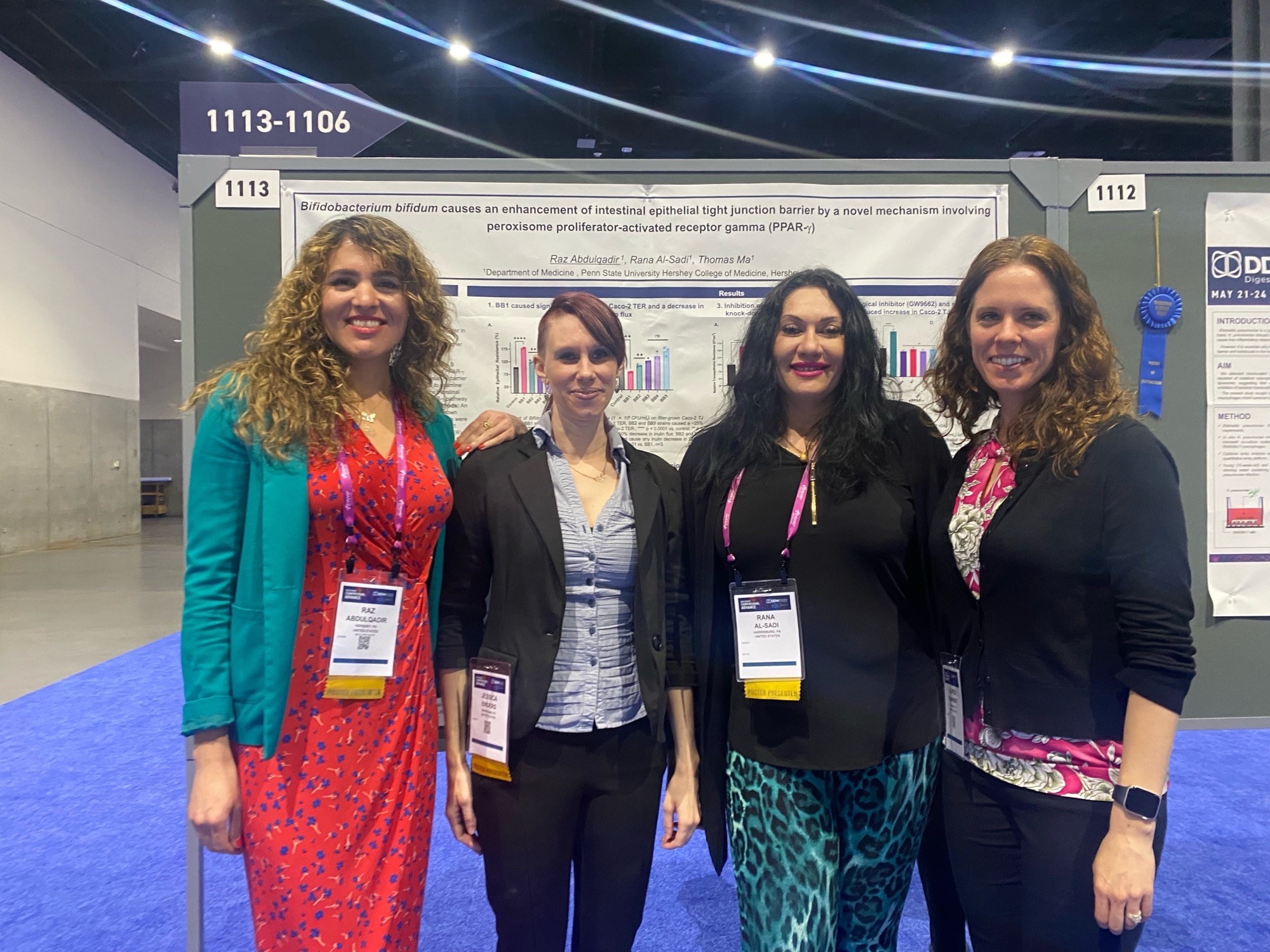 Dr. Raz Abdulqadir, left, gastroenterology fellow; Jessica Engers, research technologist; Dr. Rana Al-Sadi, researcher and assistant professor of medicine; and Dr. Lauren Kaminsky, allergy and immunology fellow, stand for a group photo in front of a research poster filled with text and graphics that was presented at the global Digestive Disease Week conference.