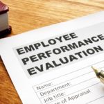 Employee performance evaluation form on a desk.
