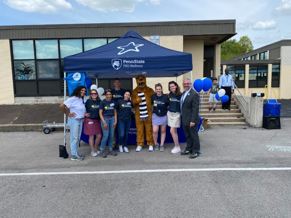 Penn State PRO Wellness Staff and Hancock Elementary administrators pose for a photo at the Move It Outside event.