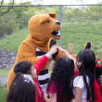 The Nittany Lion cheers on children.