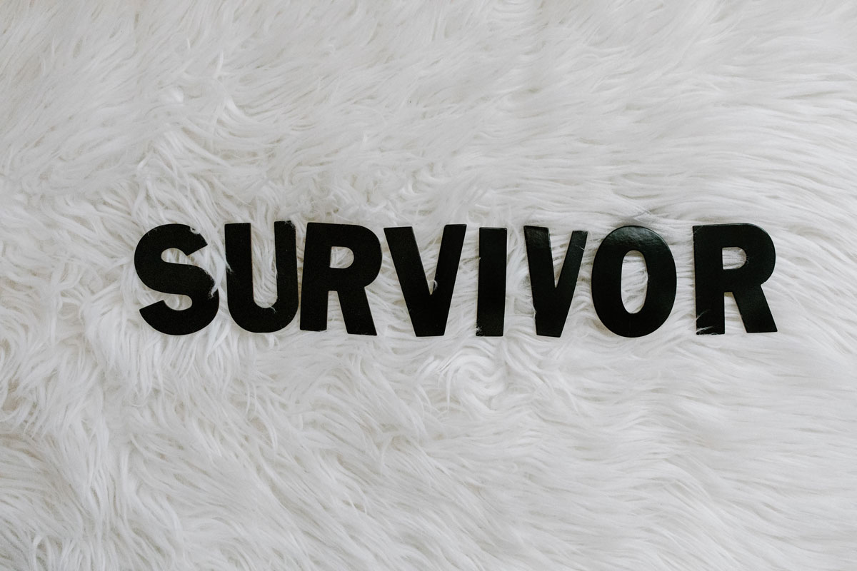 Words that spell out survivor in black inck