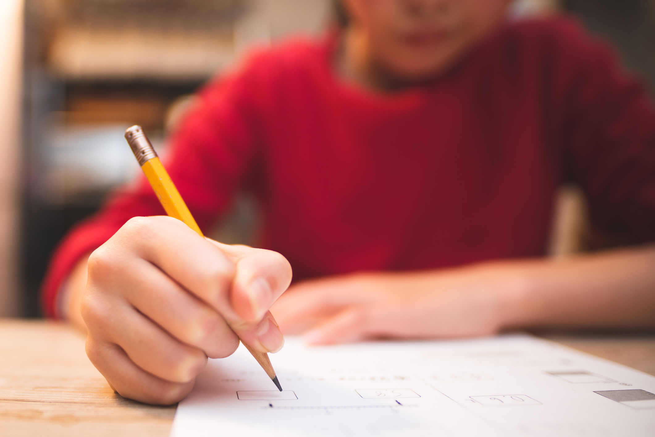 Hands of a child studying